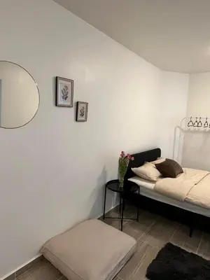 a bedroom with a bed and a table and a mirror at Rue blaes Appartement in Brussels