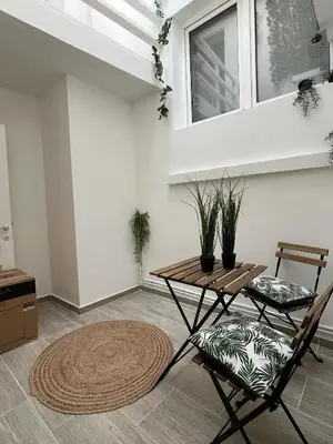 a living room with a table and two chairs at Rue blaes Appartement in Brussels
