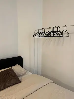 a bedroom with a bed and a shelf on the wall at Rue blaes Appartement in Brussels