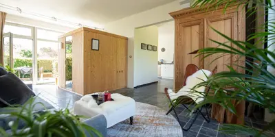 a living room with a white couch and chairs at B&B Art'Aviation in Beauvechain