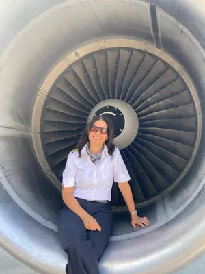 a woman sitting in front of an airplane turbine at B&B Art'Aviation in Beauvechain