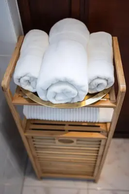 a group of folded towels on a shelf at Résidence Orchidée in Zaventem