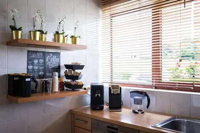 a kitchen with a sink and a counter with a coffee maker at Résidence Orchidée in Zaventem