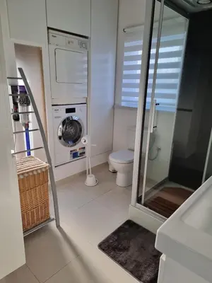a bathroom with a washing machine and a toilet at Guest House Scheldevallei in Merelbeke