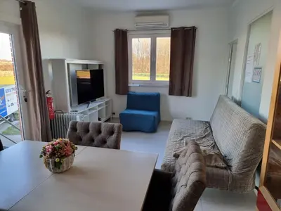a living room with a couch and a table at Guest House Scheldevallei in Merelbeke