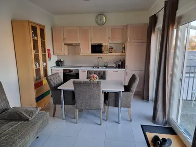 a kitchen with a table and chairs in a room at Guest House Scheldevallei in Merelbeke