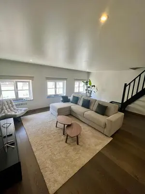 a living room with a couch and a table at Stilias Apartment 6P City Center in Brussels