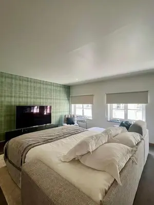 a bedroom with a large bed and a flat screen tv at Stilias Apartment 6P City Center in Brussels