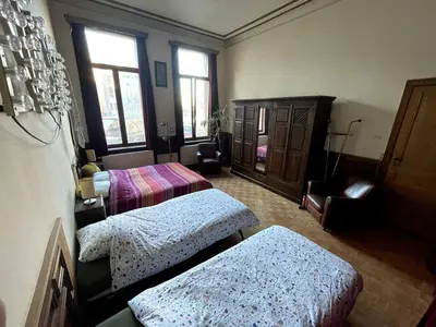a room with two beds and a cabinet and windows at Spacy Room in Old Townhouse Relaxed Vibe with LATE Check-out! in Ghent