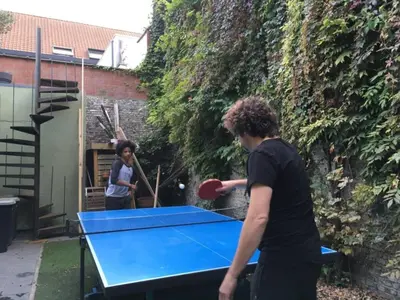 two people playing ping pong on a ping pong table at Spacy Room in Old Townhouse Relaxed Vibe with LATE Check-out! in Ghent