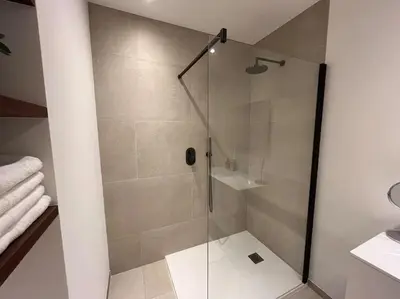 a shower with a glass door in a bathroom at House of Legend in Antwerp