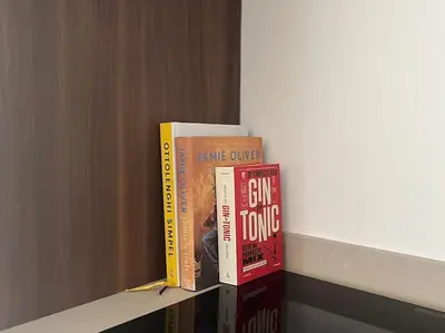 three books sitting on top of a shelf at House of Legend in Antwerp