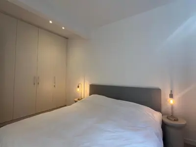 a bedroom with a white bed and two lamps at House of Legend in Antwerp