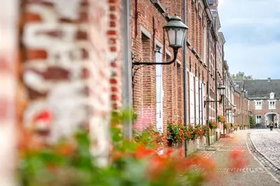 a brick building with a street light on the side of it at B&B CONVENT Begijnhof Herentals in Herentals