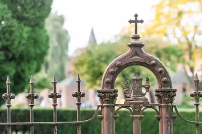a metal fence with a cross on top of it at B&B CONVENT Begijnhof Herentals in Herentals
