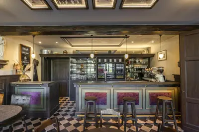 a bar in a restaurant with stools at B&B CONVENT Begijnhof Herentals in Herentals