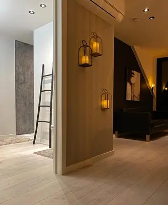 a hallway with two lights on the wall and a staircase at Penthouse with Airconditioning and Big Terrace, Close to Gent Sint-Pieters Station and City Centre in Ghent