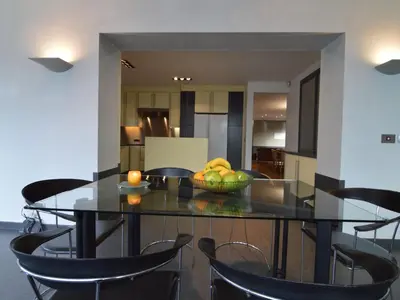 a dining room table with a bowl of fruit on it at Villa in Zottegem with Pool and Sauna in Wolvenhoek