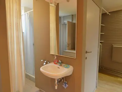 a bathroom with a sink and a mirror at Villa in Zottegem with Pool and Sauna in Wolvenhoek