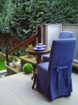 a blue chair and a table on a patio at Apartment Capitalcondos in Ninove