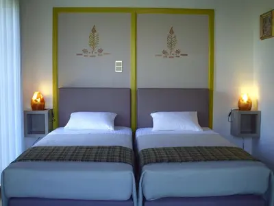 two beds sitting next to each other in a room at Apartment Capitalcondos in Ninove