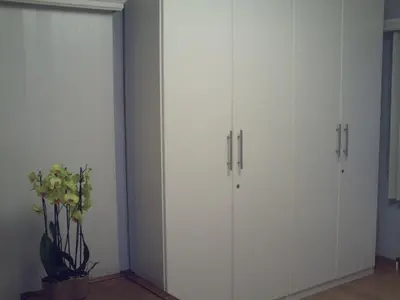 two white cabinets in a room with a plant at Apartment Capitalcondos in Ninove