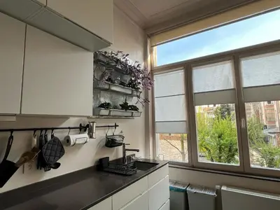 a kitchen with a sink and a window at Appartement Voltaire in Brussels