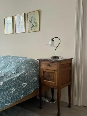 a bedroom with a bed and a lamp on a nightstand at Appartement Voltaire in Brussels
