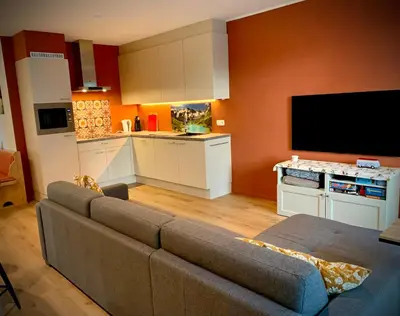 a living room with a couch and a kitchen at Olivia in Lier