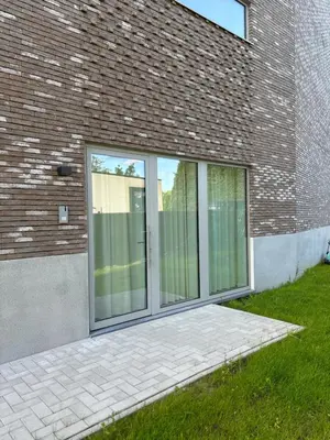 a glass door on the side of a brick building at Olivia in Lier