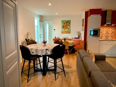 a kitchen and a living room with a table and chairs at Olivia in Lier