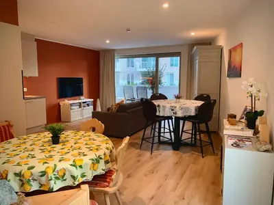 a kitchen and living room with a table and a living room at Olivia in Lier