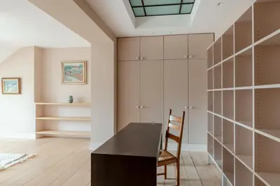 a dining room with a black table and a chair at Brussels EU Prestige residence in Brussels