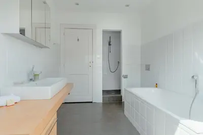 a white bathroom with two sinks and a tub at Brussels EU Prestige residence in Brussels