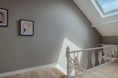 a staircase with white walls and a skylight at Brussels EU Prestige residence in Brussels
