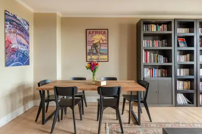 a dining room with a wooden table and chairs at Brussels EU Prestige residence in Brussels
