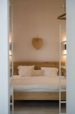 a bedroom with a bunk bed with white sheets and pillows at FLAX ANTWERP in Antwerp