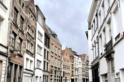 a city street with tall buildings on a cloudy day at FLAX ANTWERP in Antwerp