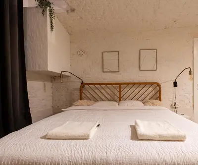 a bedroom with a large bed with two towels on it at FLAX ANTWERP in Antwerp