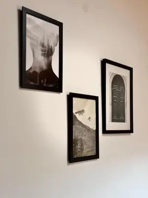 three framed pictures hanging on a white wall at Studio n3 Bruxelles Centre Ville in Brussels