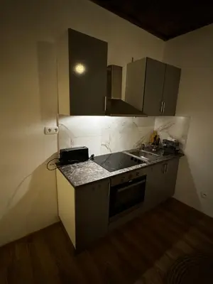 a small kitchen with a sink and a stove at Studio n3 Bruxelles Centre Ville in Brussels