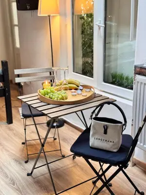 a table with a plate of fruit and a purse on it at Studio n3 Bruxelles Centre Ville in Brussels