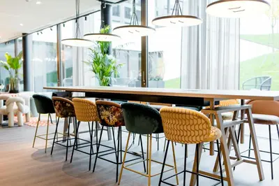 a dining room with a large table and chairs at Motel One Antwerp in Antwerp