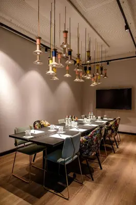 a conference room with a long table and chairs at Motel One Antwerp in Antwerp