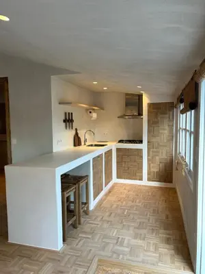 a kitchen with a white island in a room at Chalet Leon in Geel