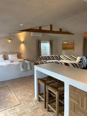 a bedroom with a bed and a table in a room at Chalet Leon in Geel
