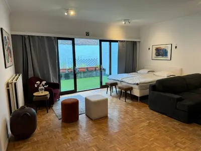 a living room with a bed and a couch at Garden loft in city center Meir 1FL in Antwerp