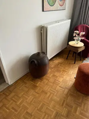 a vase sitting on the floor in a living room at Garden loft in city center Meir 1FL in Antwerp