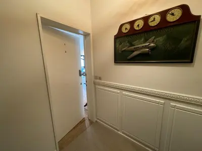 a hallway with a clock on the wall next to a door at Garden loft in city center Meir 1FL in Antwerp