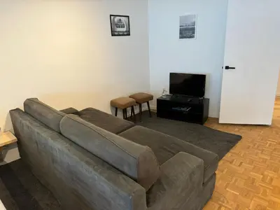 a living room with a couch and a flat screen tv at Garden loft in city center Meir 1FL in Antwerp